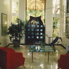 Contemporary Sunroom with black leather lounge chairs
