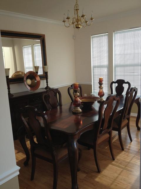 Transitional Dining Room with dark dining table and chairs