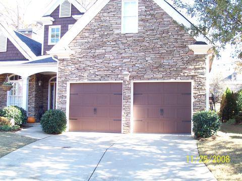 Traditional Garage with dark wood shingle siding