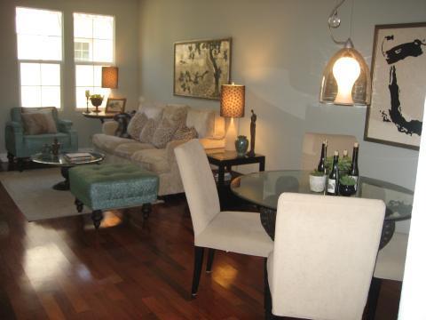 Eclectic Family Room with light blue upholstered ottoman with dark wood legs