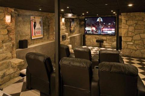 Eclectic Home Theater with black leather lounge chairs