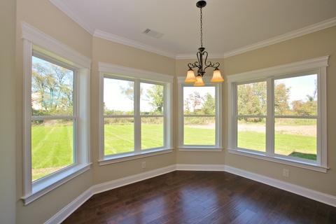Transitional Dining Room with dark hardwood flooring