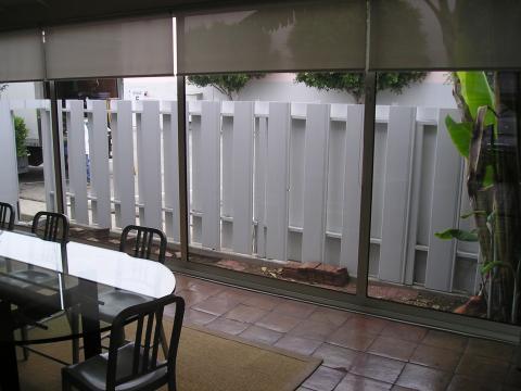 Contemporary Sunroom with white privacy fence outside