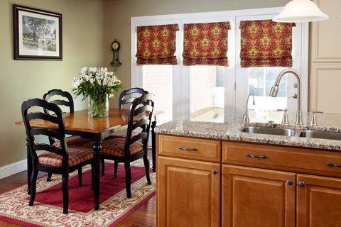 Traditional Dining Room with medium wood stained cabinets