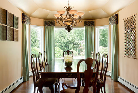 Transitional Dining Room with decorative mirror