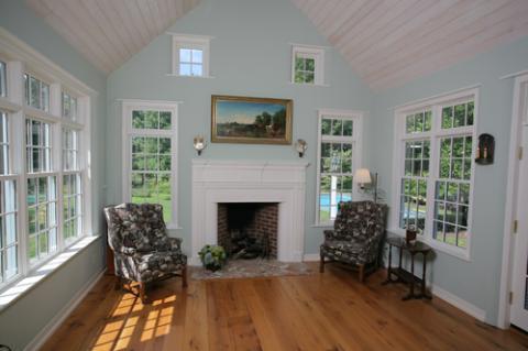 Cape Cod Sunroom with wide plank hardwood flooring