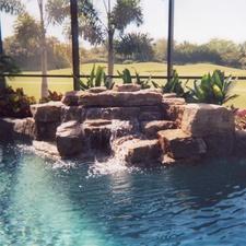 Traditional Sunroom with water fall into pool