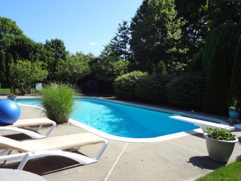 Traditional Pool with outdoor lounge chairs