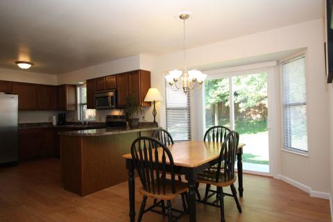 Traditional Dining Room with stained wood and black dining table