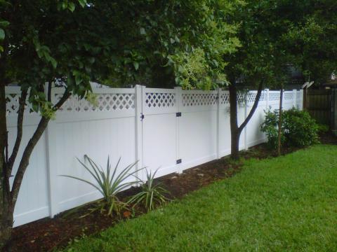 Transitional Landscape with flower garden lining fence