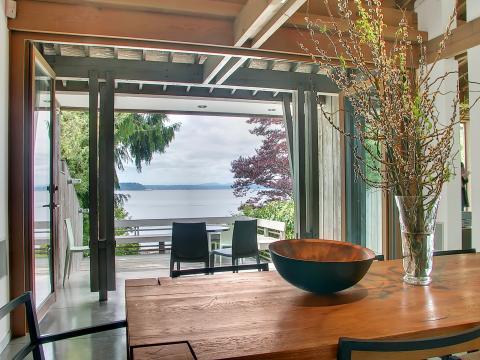 Contemporary Dining Room with large glass vase with sticks center piece