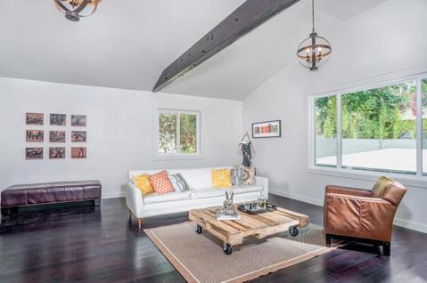 Eclectic Family Room with exposed dark stained ceiling beam