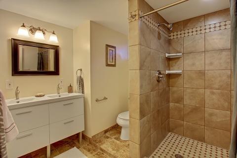 Transitional Bathroom with dark wood framed vanity mirror