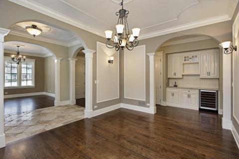 Transitional Dining Room with wrought iron chandelier