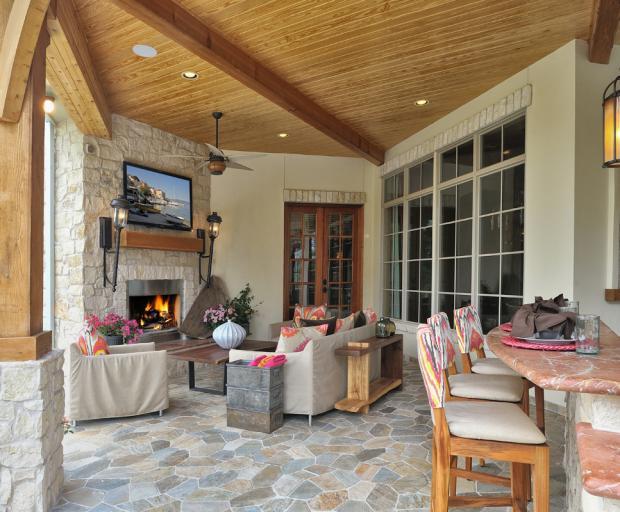Rustic Patio with stacked stone fireplace