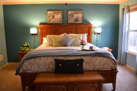 Traditional Bedroom with small light wood bedside dressers