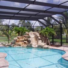 Contemporary Sunroom with cobblestone patio around pool