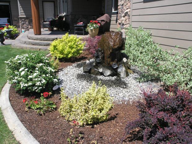 Transitional Garden with large stone water fall feature
