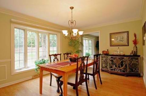 Transitional Dining Room with light green painted walls