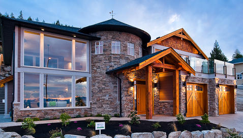 Eclectic Home Exterior with plexi glass deck railing