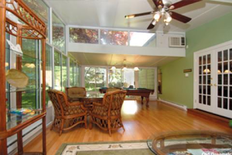 Transitional Sunroom with glass and wood french doors