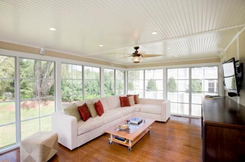 Transitional Sunroom with light wood coffee table with glass panels
