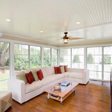 Transitional Sunroom with light wood coffee table with glass panels
