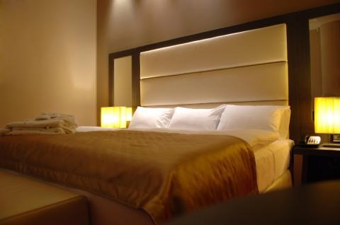 Contemporary Bedroom with beige upholstered head boars