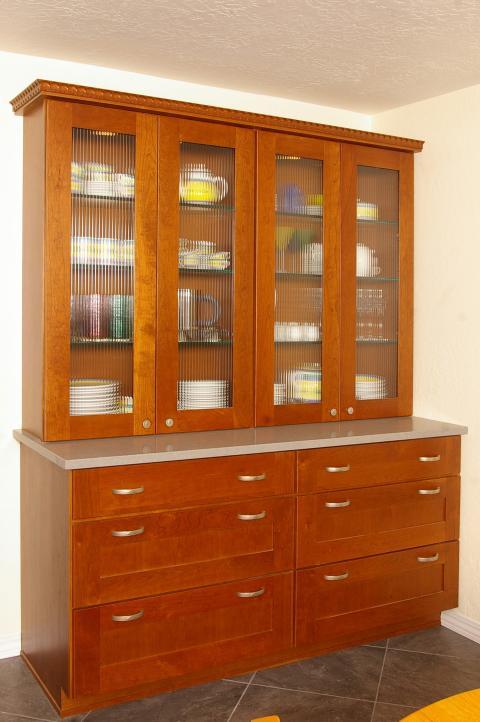 Traditional Dining Room with glassed top cabinet doors