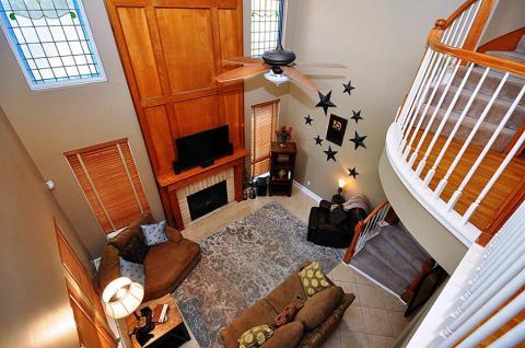 Eclectic Family Room with wood accent wall above fire place