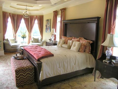 Traditional Bedroom with dark wood bed frame with large headboard