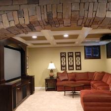 Traditional Family Room with dark wood built-in wall hung cabinet