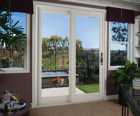 Contemporary Home Office with bypass sliding glass doors