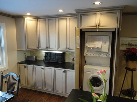 Transitional Home Office with hidden stacking washer and dryer