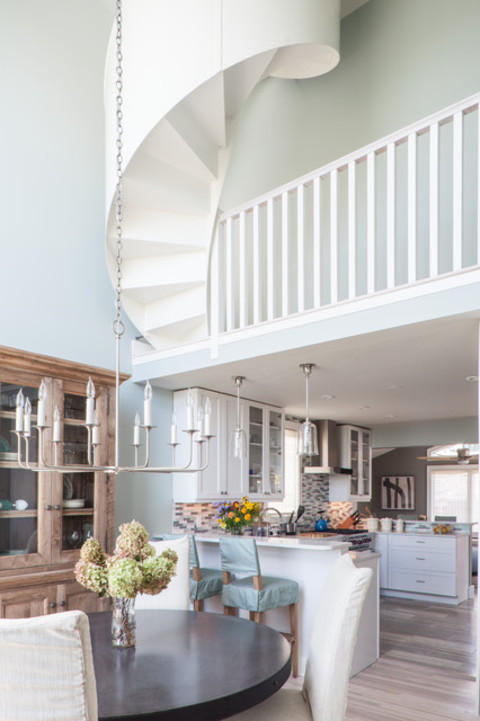 Eclectic Dining Room with white recessed panel cabinets