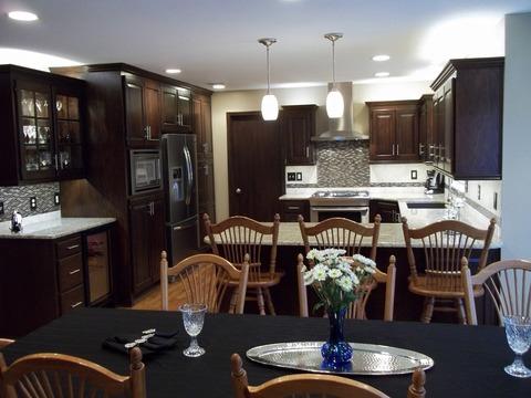 Traditional Dining Room with dark mosaic tile back splash