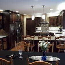 Traditional Dining Room with dark mosaic tile back splash
