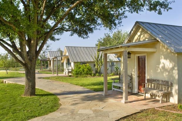 Cottage Patio with pale yellow painted home exterior