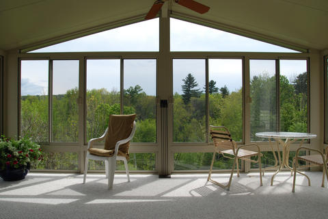 Contemporary Sunroom with cream small dining table