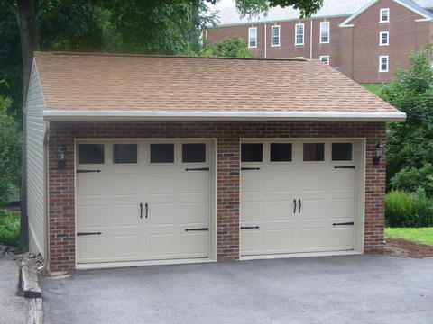 Transitional Garage with rain gutter and downspout