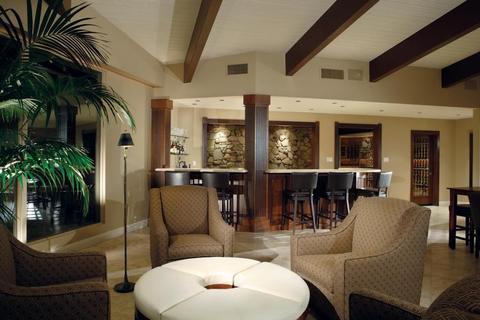 Transitional Wine Cellar with exposed stone foundation accent wall