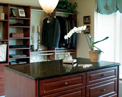 Traditional Closet with dark stained wod cabinets and shelves