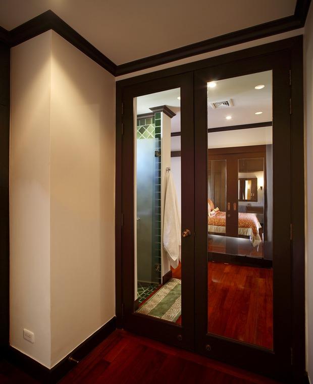Traditional Hallway with dark wood stained millwork