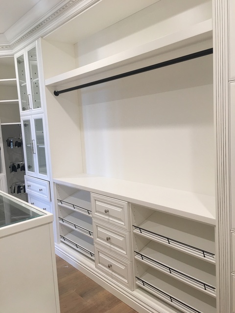 Traditional Closet with white built in cabinetry in walk in closet