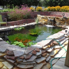 Eclectic Landscape with brick retaining wall