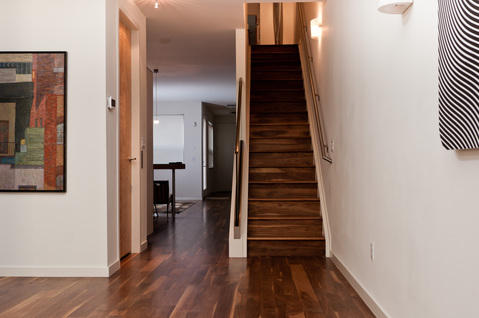 Modern Entry with dark wood flooring