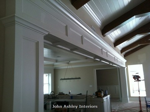 French Country Dining Room with arched ceiling buttressing