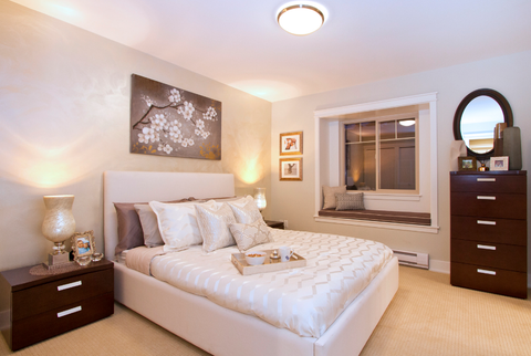 Contemporary Bedroom with wall to wall tan carpet