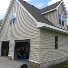 Transitional Garage with beige painted siding