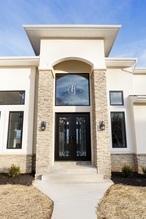 Modern Home Exterior with decorative iron door detail